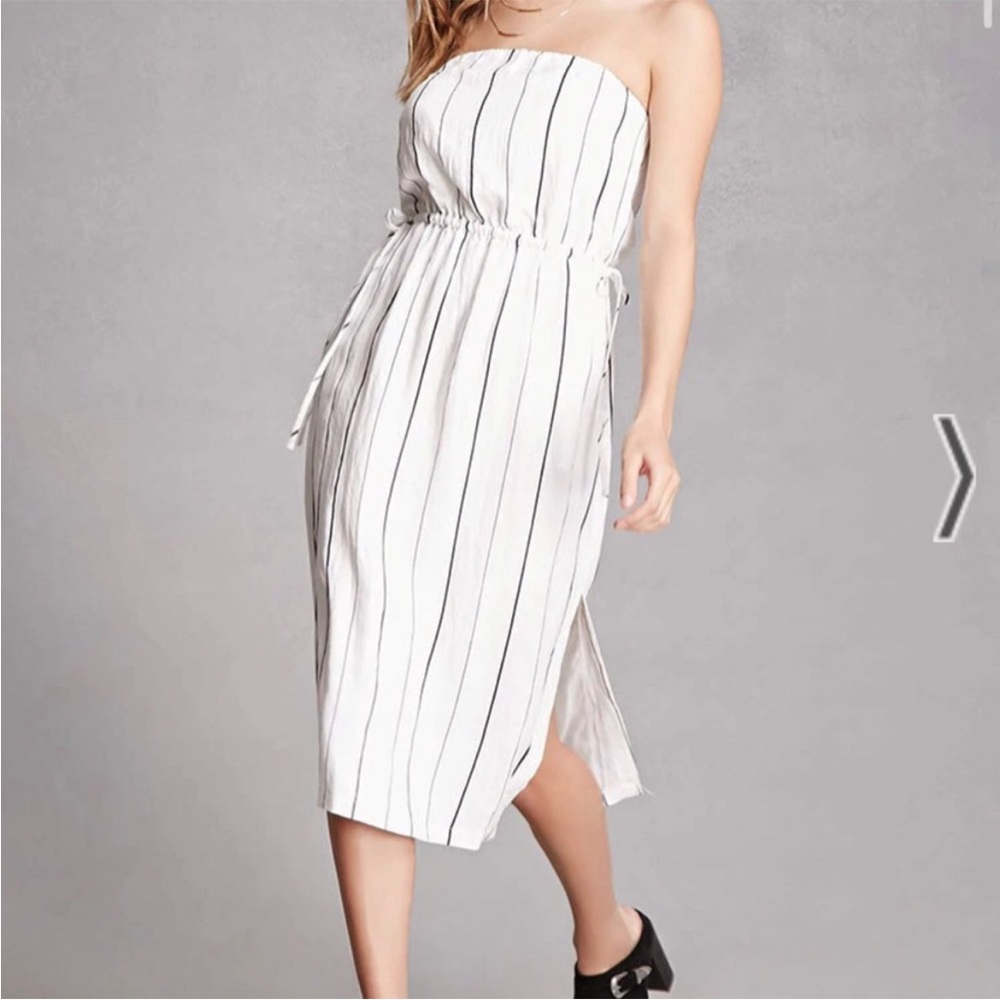 Lush strapless white dress with black vertical stripes and ties around waist.